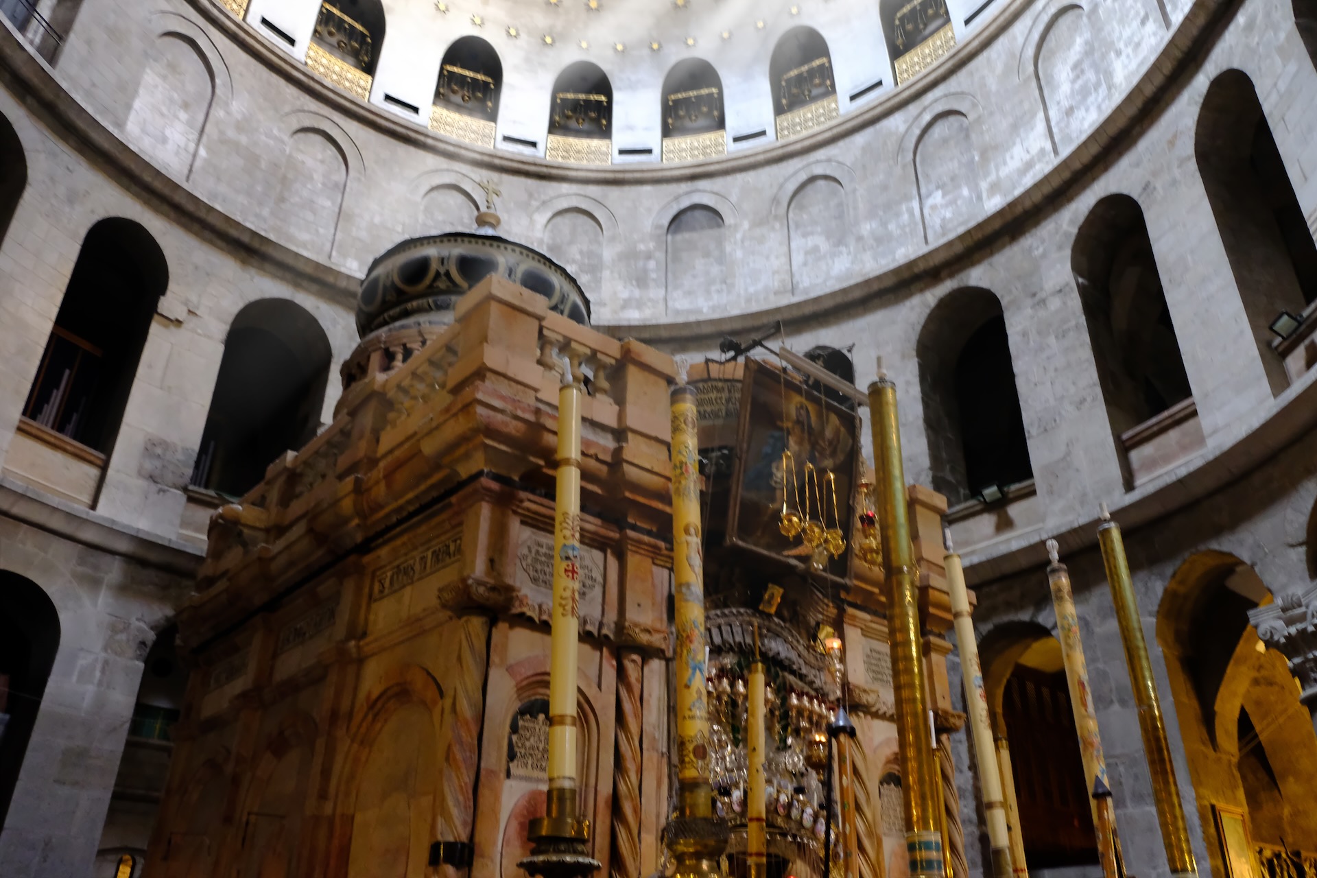 Interior view of the Church of the Holy Sepulchre with stone walls and arches in Jerusalem