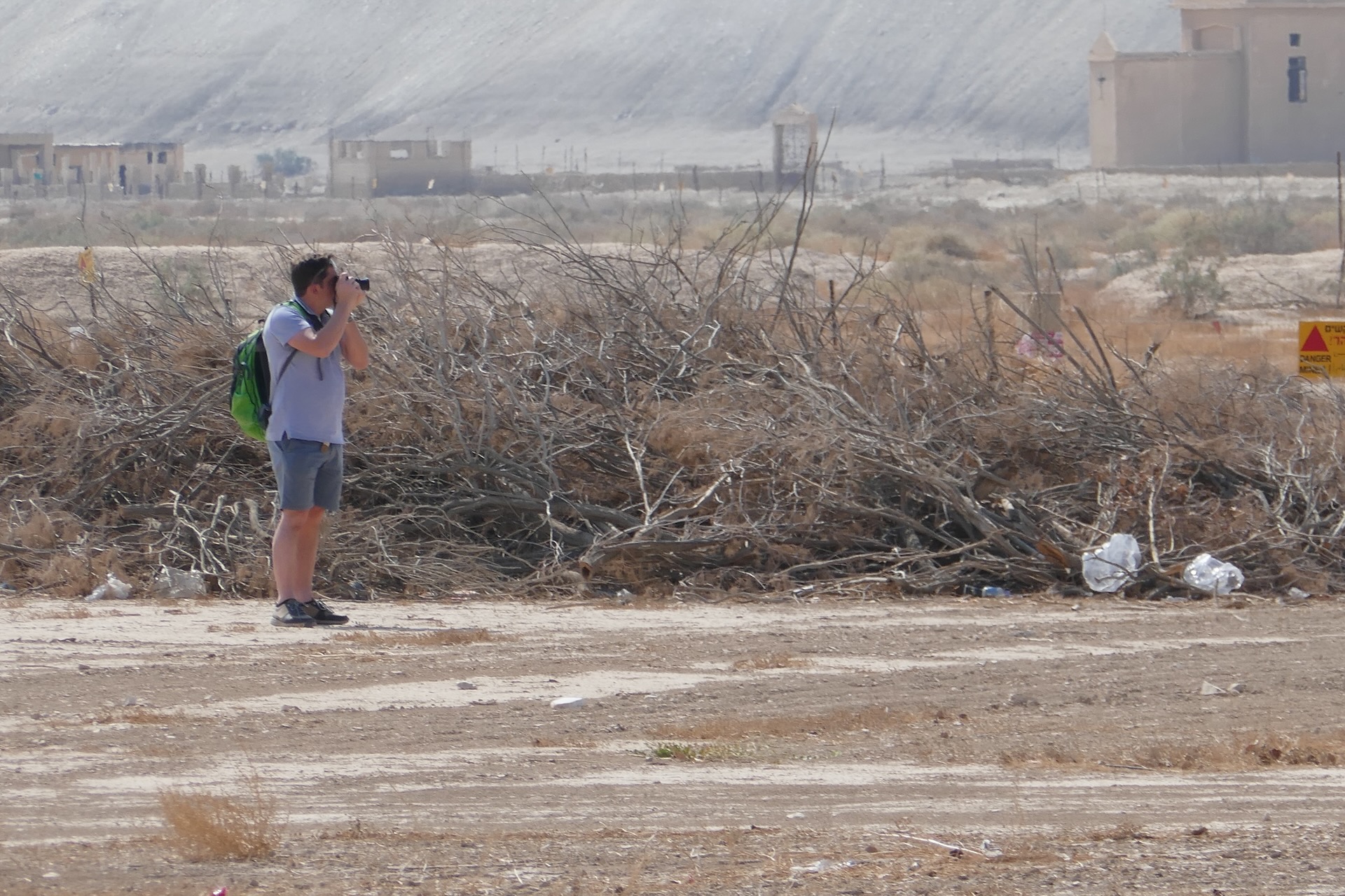 Thomas taking pictures in a dry Middle Eastern landscape